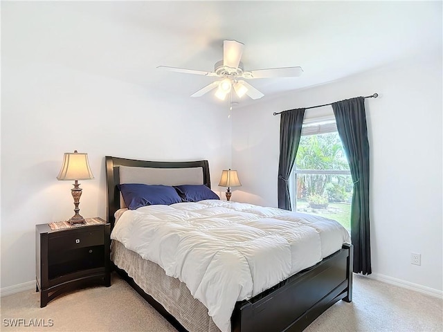 bedroom with light colored carpet and ceiling fan