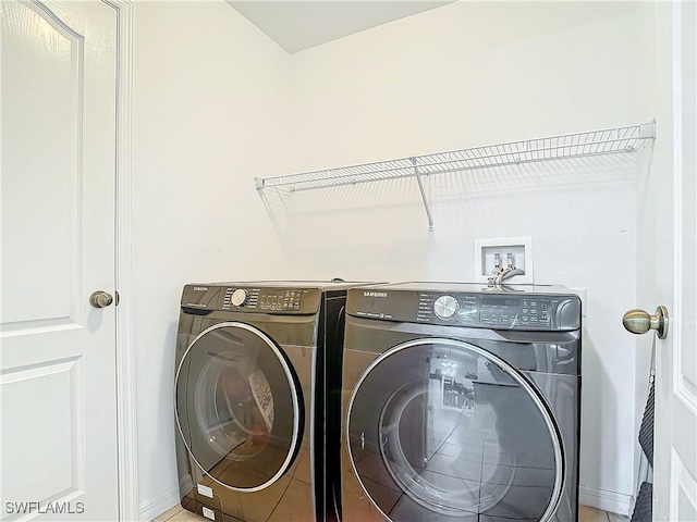 clothes washing area featuring independent washer and dryer