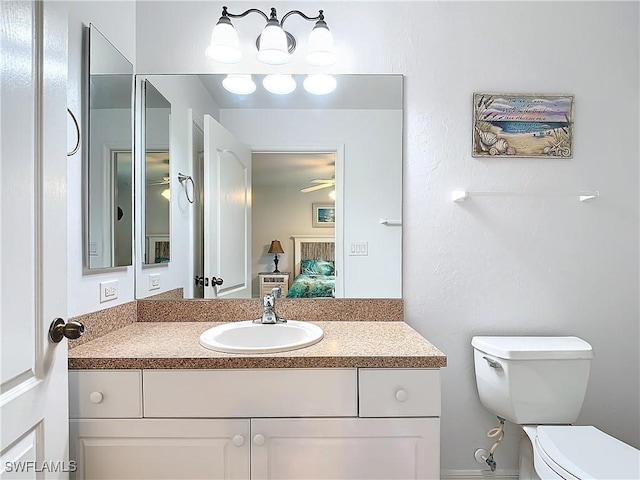 bathroom featuring ceiling fan, toilet, and vanity