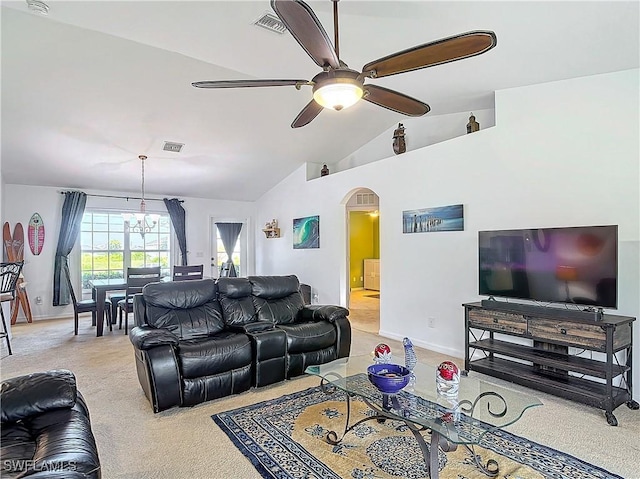 living room featuring ceiling fan with notable chandelier, light colored carpet, and vaulted ceiling