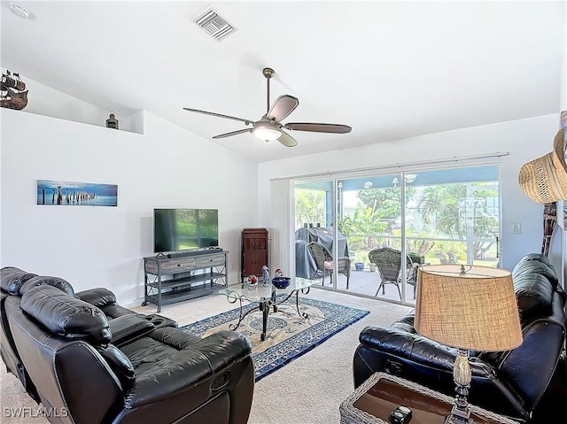 living room featuring ceiling fan, carpet floors, and vaulted ceiling