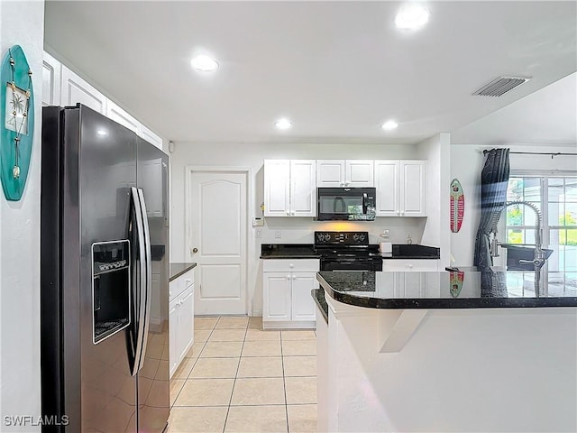 kitchen featuring black appliances, white cabinetry, and light tile patterned floors