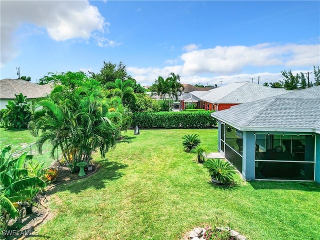 view of yard featuring a sunroom