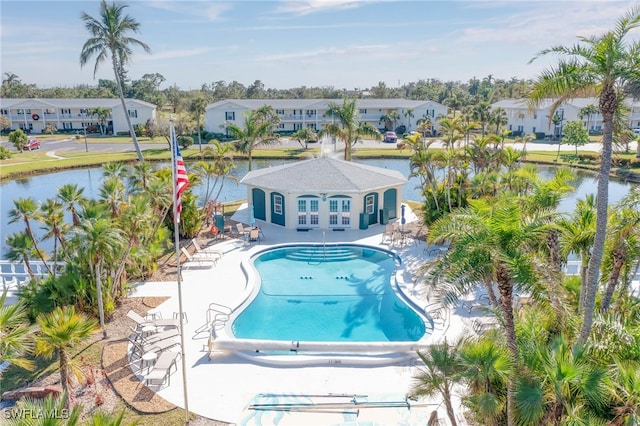 view of pool with a water view and a patio area