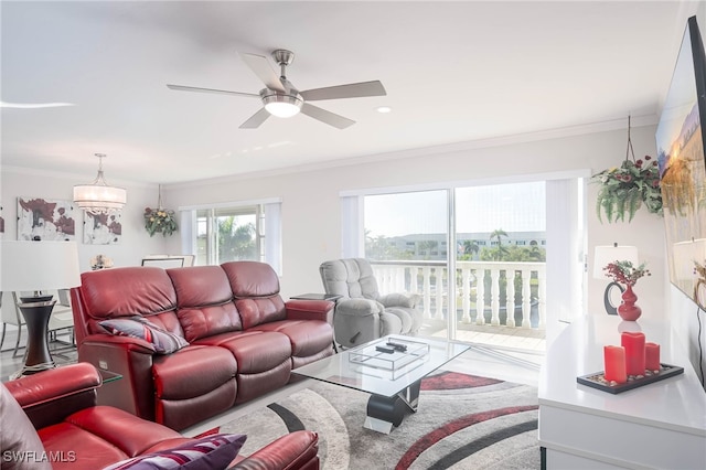 living room with ceiling fan and ornamental molding