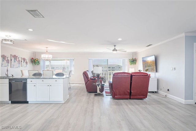 living room featuring light hardwood / wood-style floors, ceiling fan, crown molding, and sink