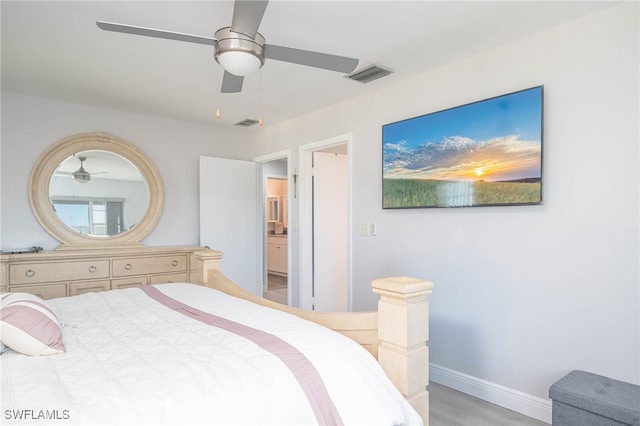 bedroom with light wood-type flooring, ceiling fan, and connected bathroom