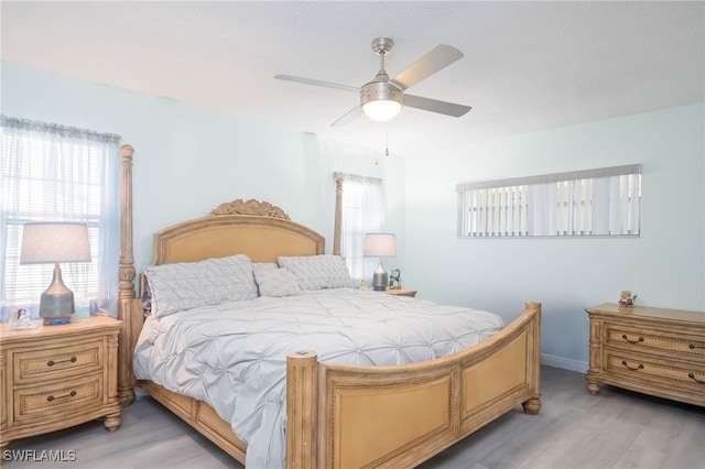 bedroom with ceiling fan and wood-type flooring