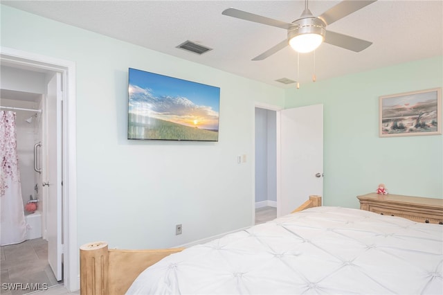 tiled bedroom featuring a textured ceiling and ceiling fan