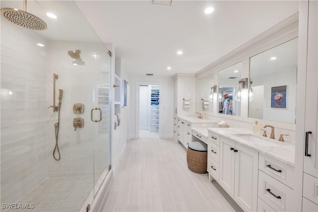 bathroom featuring vanity and a shower with shower door