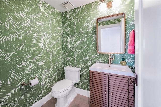 bathroom featuring tile patterned flooring, vanity, and toilet