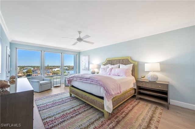 bedroom with light wood-type flooring, ceiling fan, and crown molding