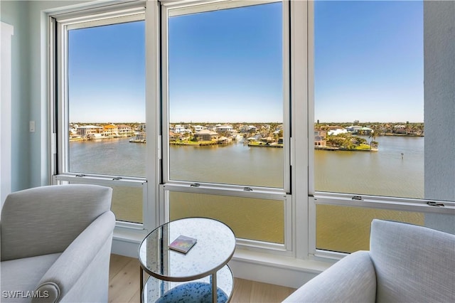 sunroom / solarium featuring a water view