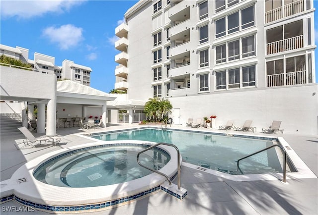 view of pool featuring a patio area and a community hot tub