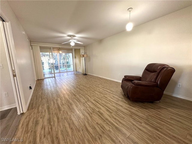 living area featuring ceiling fan and wood-type flooring