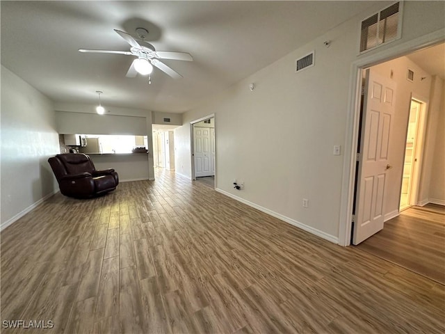 interior space featuring ceiling fan and dark hardwood / wood-style flooring