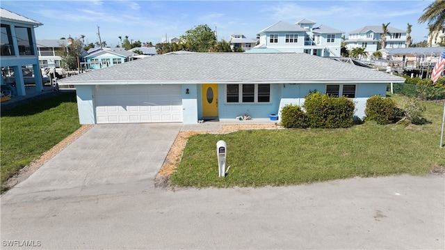 view of front of house with a garage and a front yard