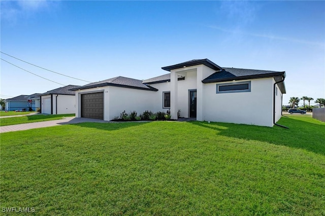 prairie-style home with a garage and a front lawn