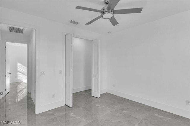 unfurnished bedroom featuring ceiling fan and a closet