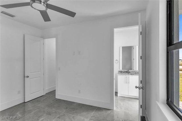 spare room featuring ceiling fan and sink