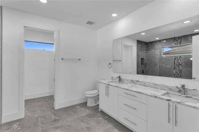 bathroom featuring vanity, toilet, and walk in shower