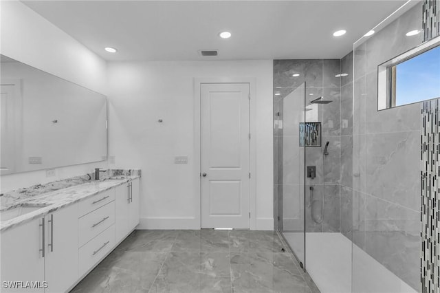 bathroom with vanity and tiled shower