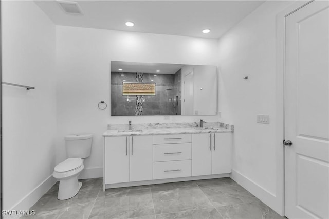 bathroom with vanity, toilet, and walk in shower