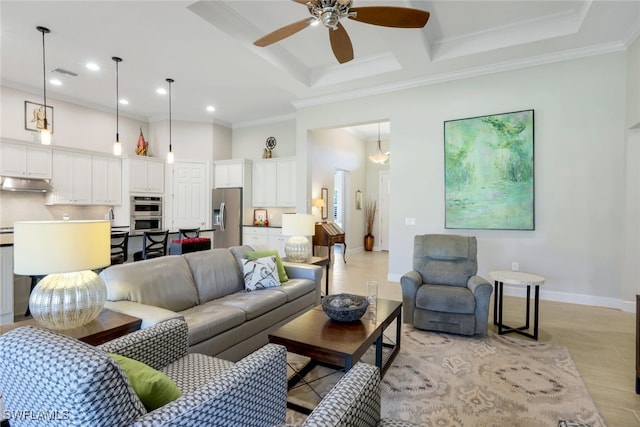 living room with visible vents, a high ceiling, ornamental molding, and a ceiling fan