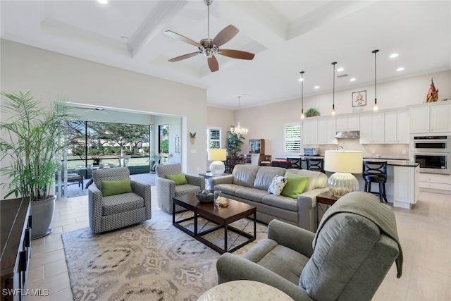 living area with coffered ceiling, ceiling fan with notable chandelier, a high ceiling, and beam ceiling