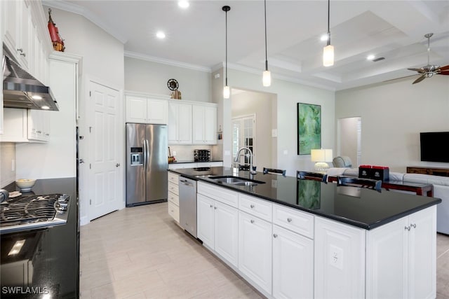 kitchen with a kitchen island with sink, dark countertops, appliances with stainless steel finishes, a sink, and open floor plan