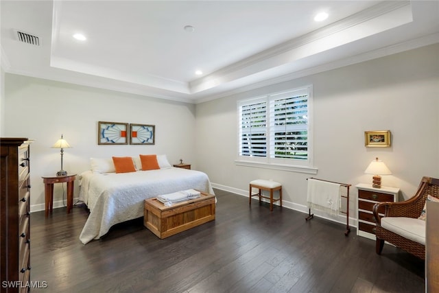 bedroom with a tray ceiling, visible vents, crown molding, and dark wood-type flooring