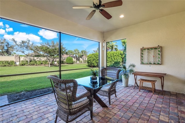 sunroom featuring a ceiling fan
