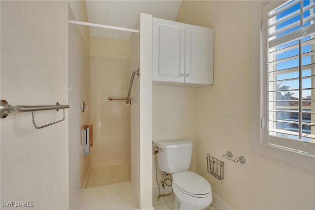 bathroom with tile patterned floors, toilet, and a shower