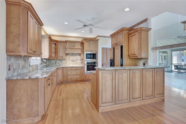 kitchen featuring light wood-type flooring, light brown cabinetry, built in appliances, and ornamental molding