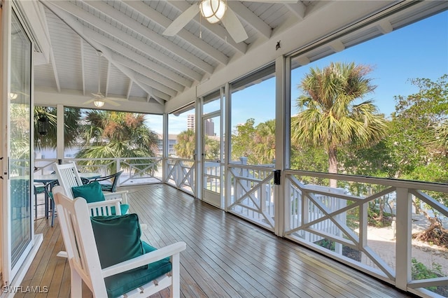 sunroom featuring vaulted ceiling with beams and ceiling fan