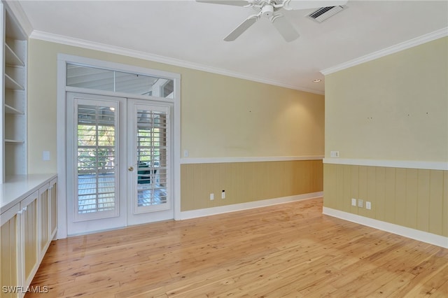 spare room with ceiling fan, french doors, light hardwood / wood-style floors, and ornamental molding