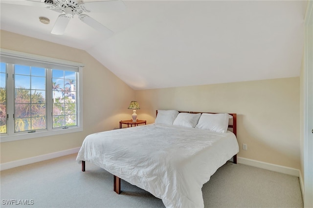 carpeted bedroom with ceiling fan and vaulted ceiling