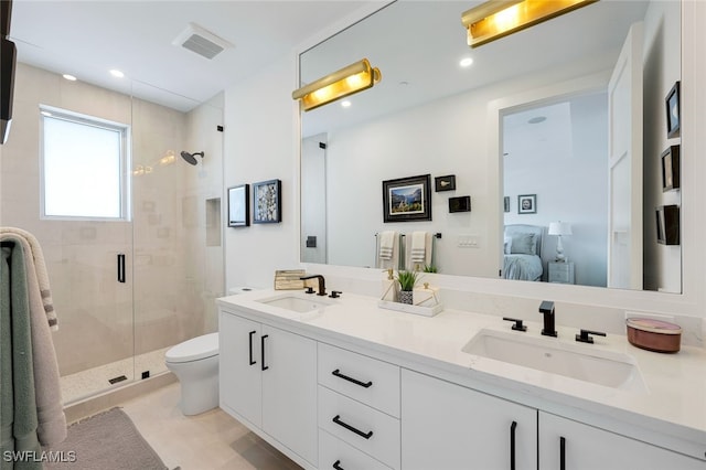 bathroom with tile patterned floors, vanity, toilet, and a shower with shower door