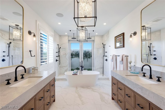 bathroom featuring vanity, independent shower and bath, and a chandelier