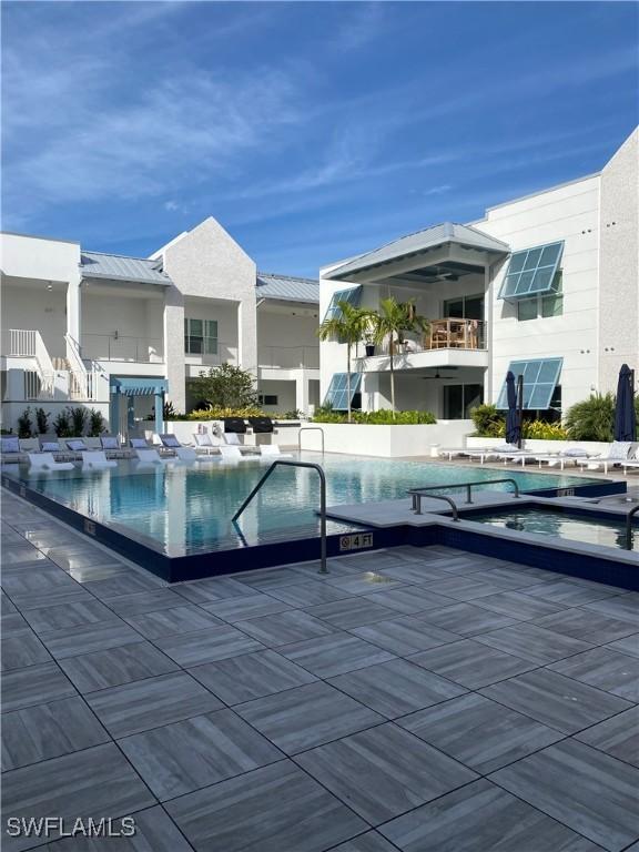 view of swimming pool with a jacuzzi