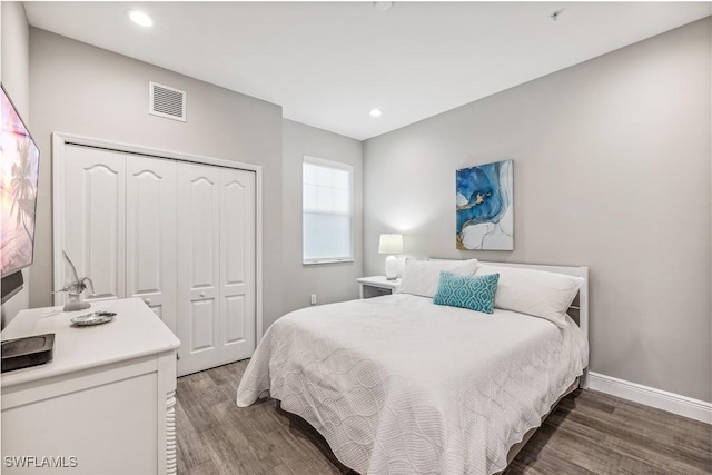 bedroom with hardwood / wood-style flooring and a closet