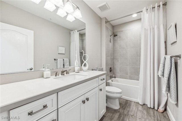 full bathroom with hardwood / wood-style flooring, vanity, toilet, and shower / bath combo with shower curtain