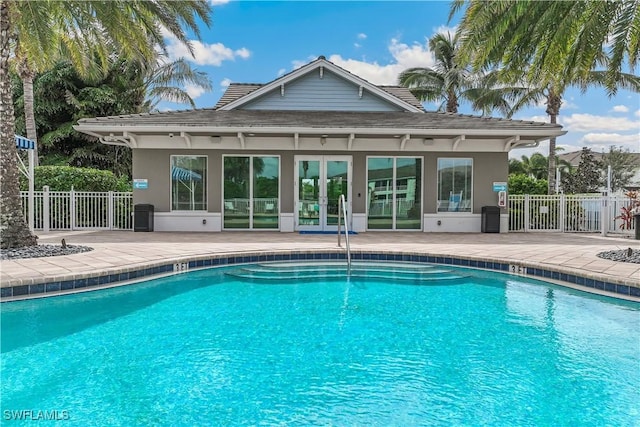 view of swimming pool featuring a patio area and french doors