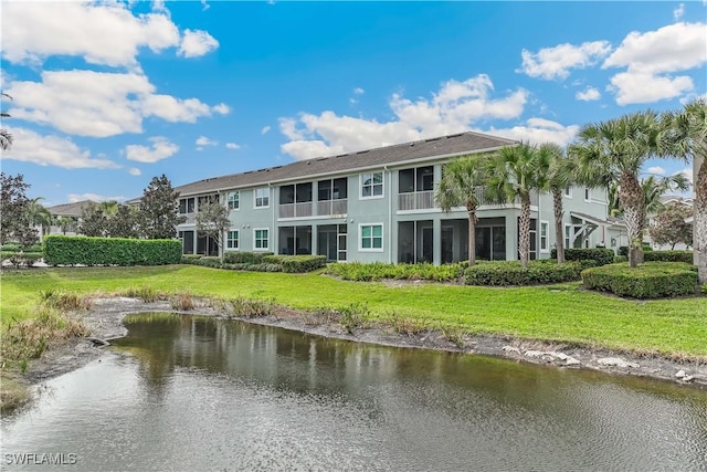 exterior space with a water view and a yard