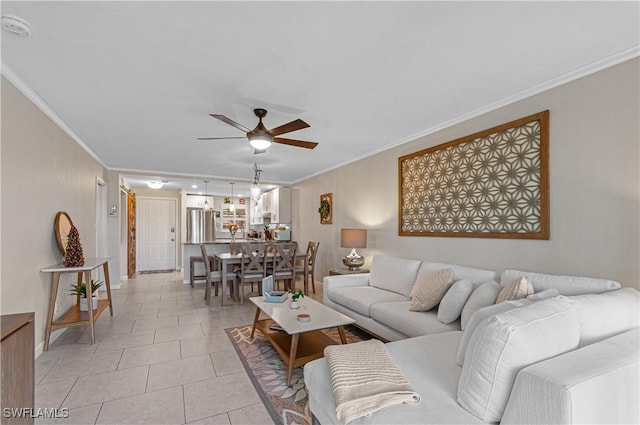 living room with ceiling fan, light tile patterned floors, and ornamental molding