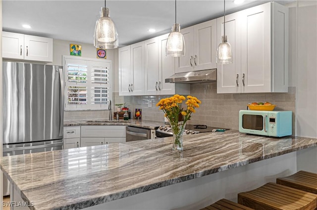 kitchen with kitchen peninsula, white cabinetry, and stainless steel appliances