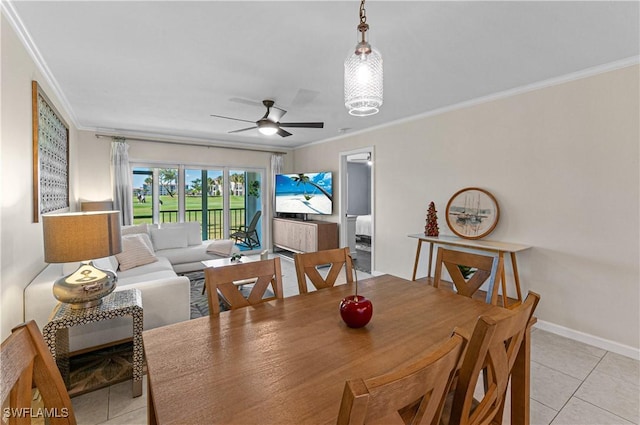 tiled dining room featuring ceiling fan and crown molding