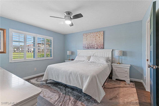 bedroom with ceiling fan and dark hardwood / wood-style flooring