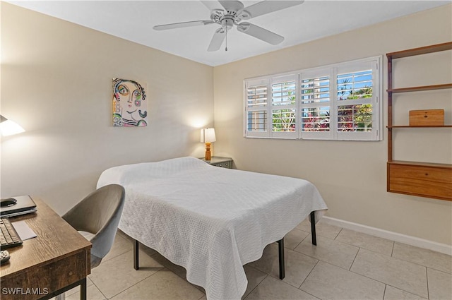 tiled bedroom featuring ceiling fan