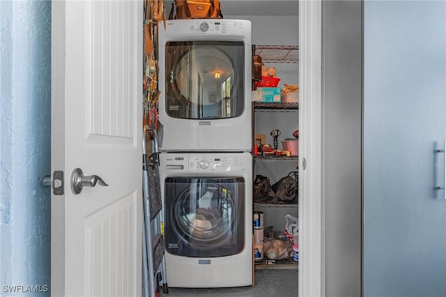 washroom with stacked washer and dryer